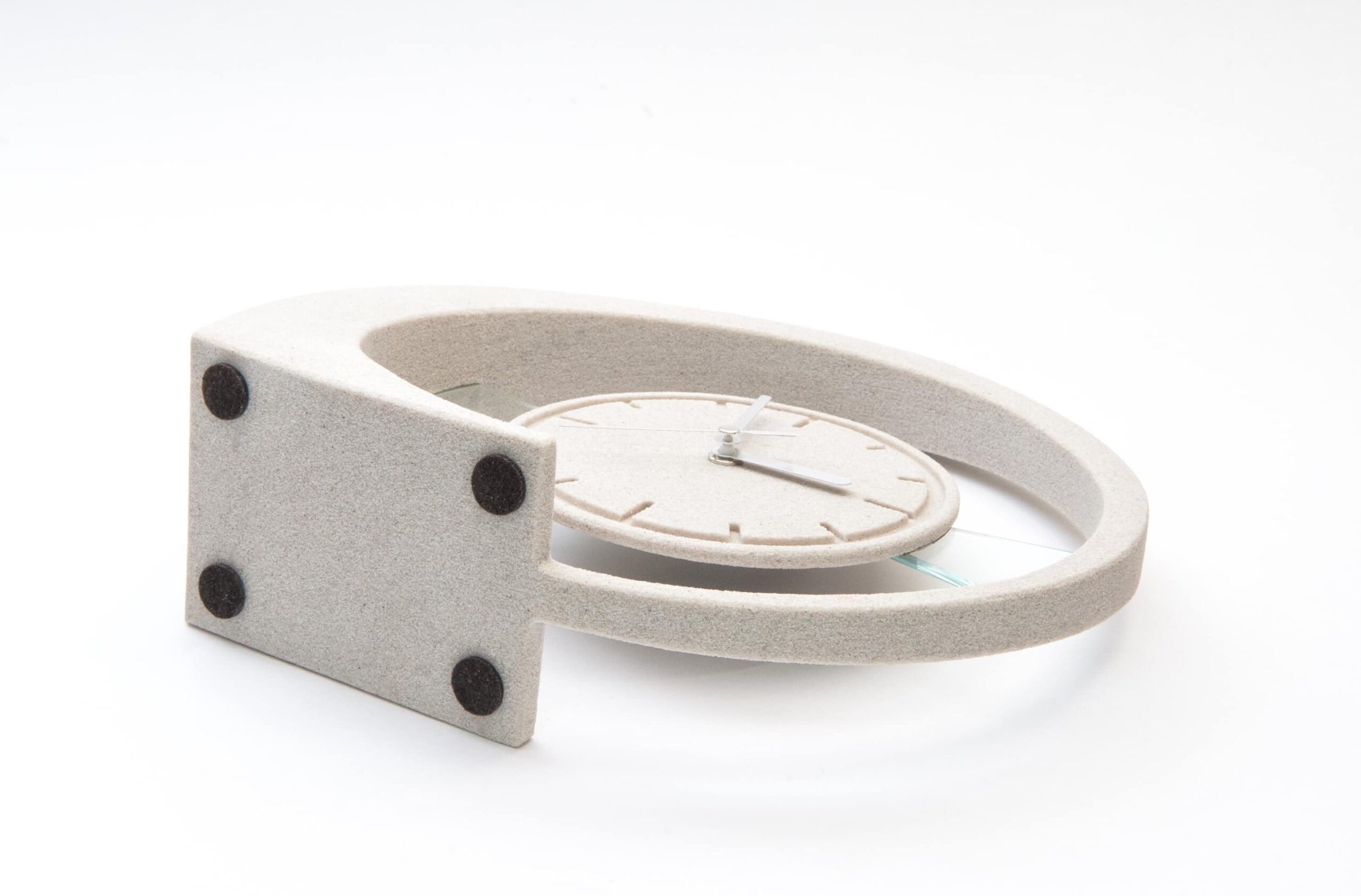 Die Unterseite der Tischuhr „Susi“ aus Sandstein, sichtbar sind vier schwarze, runde Anti-Rutsch-Pads.