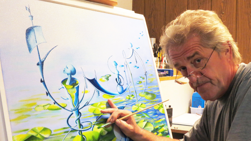 Künstler bei der Arbeit Atelier Erfurt Kunsthandwerker bei der präzisen Detailarbeit an einem großformatigen Gemälde in seiner Erfurter Werkstatt.